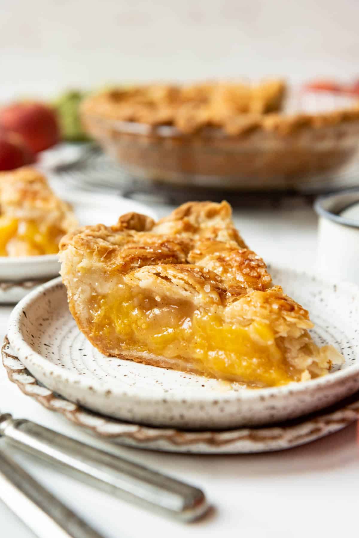 A slice of peach pie on a plate.