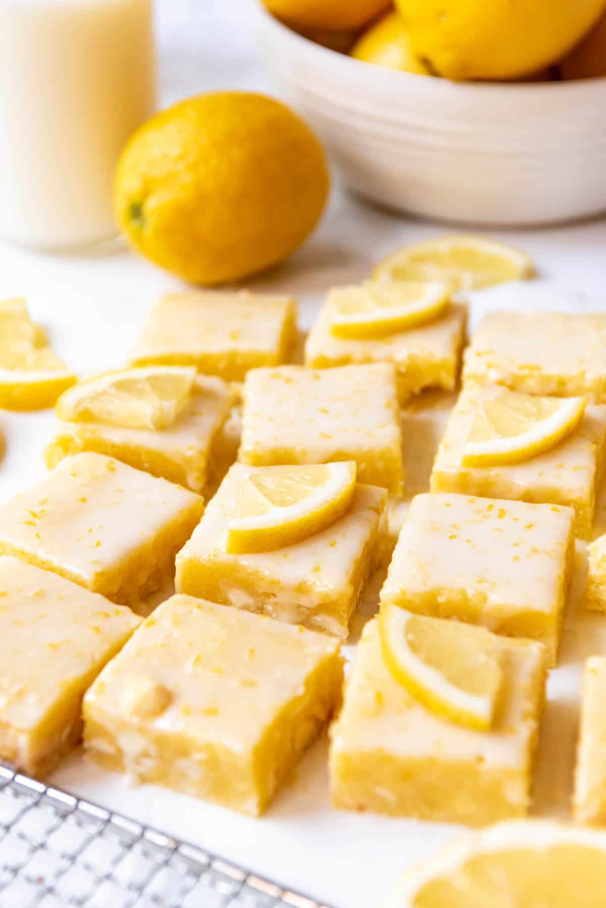 Lemon brownies with thinly sliced lemon wedges on top for decoration.