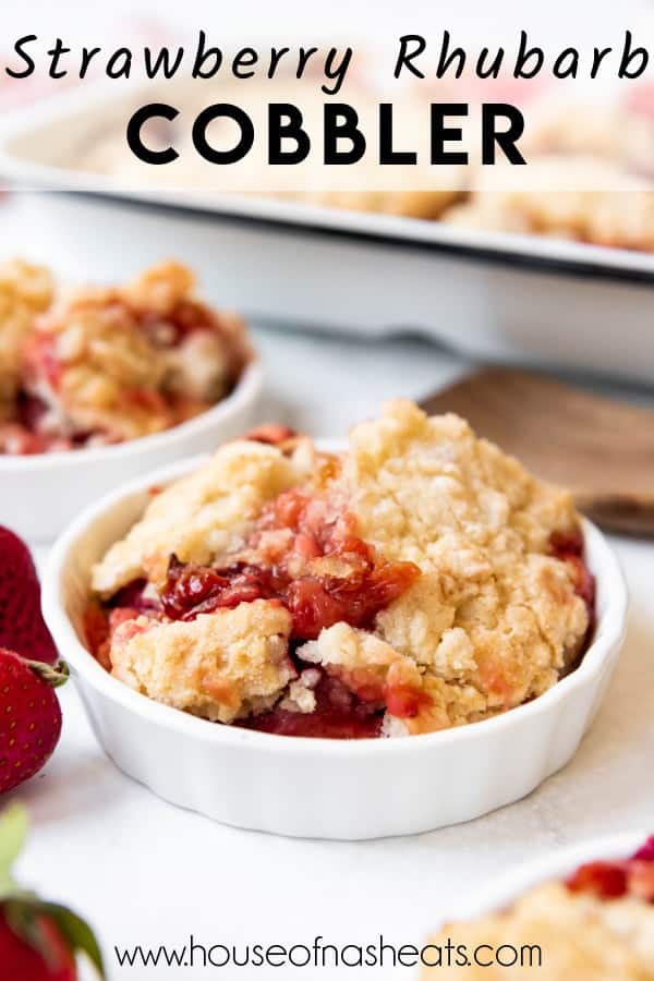 A bowl of strawberry rhubarb cobbler with text overlay.