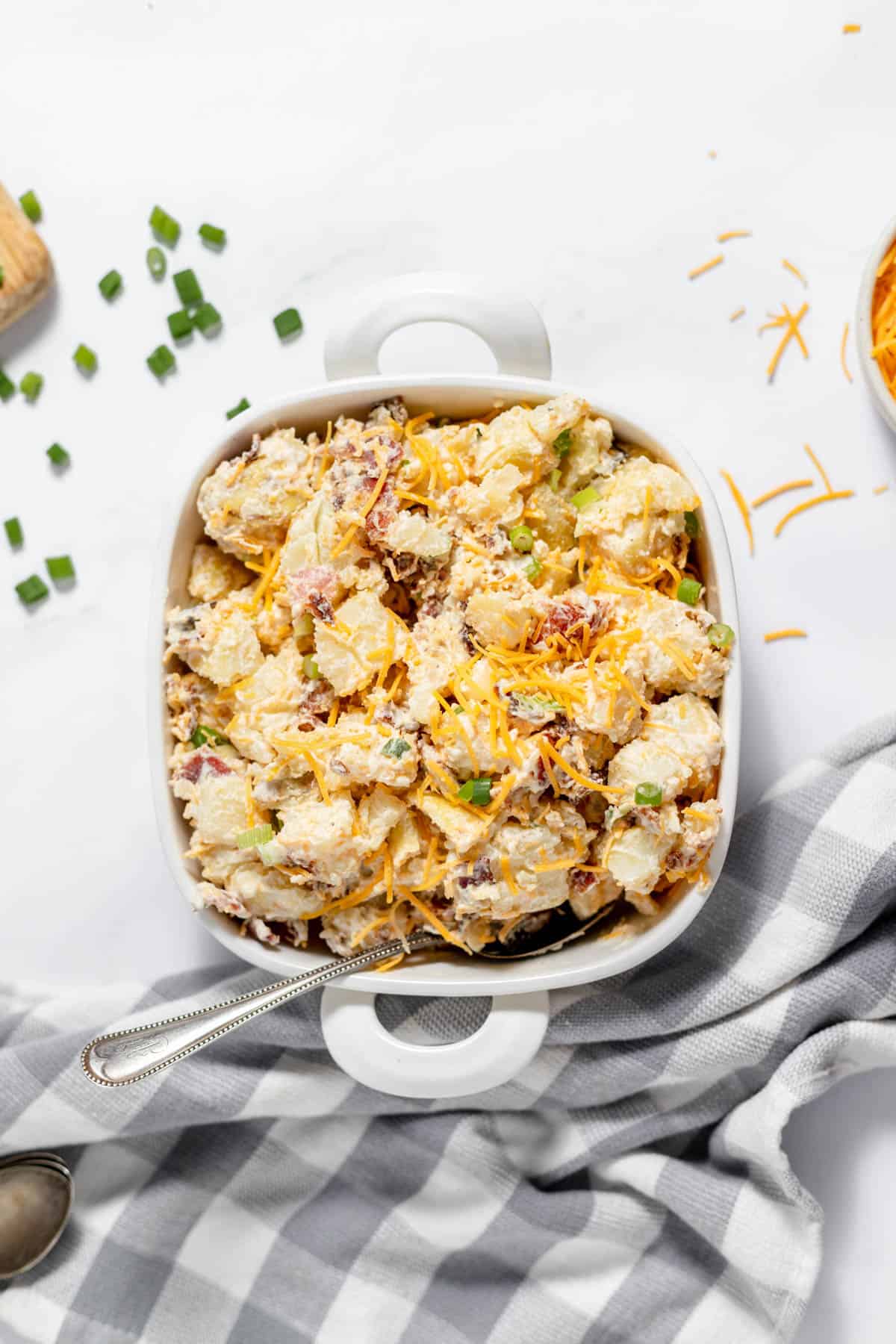 Loaded baked potato salad in a serving dish.
