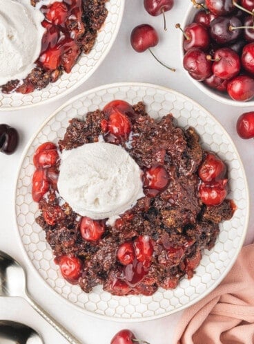 A large bowl of chocolate cherry cobbler with vanilla ice cream.