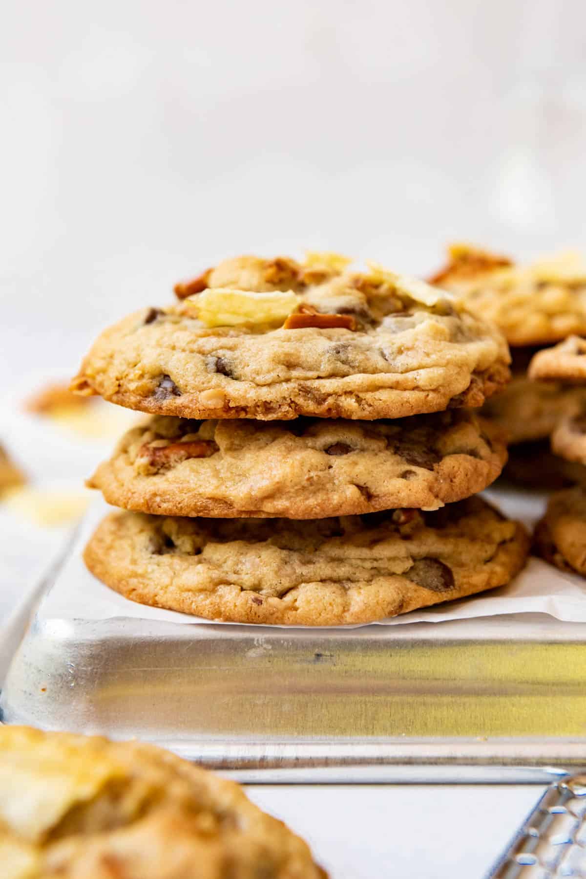 A stack of Kitchen Sink Cookies on a baking tray.