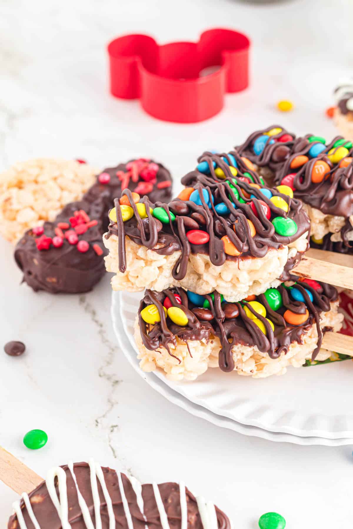 Mickey Mouse rice krispie treats with mini M&M's on top.
