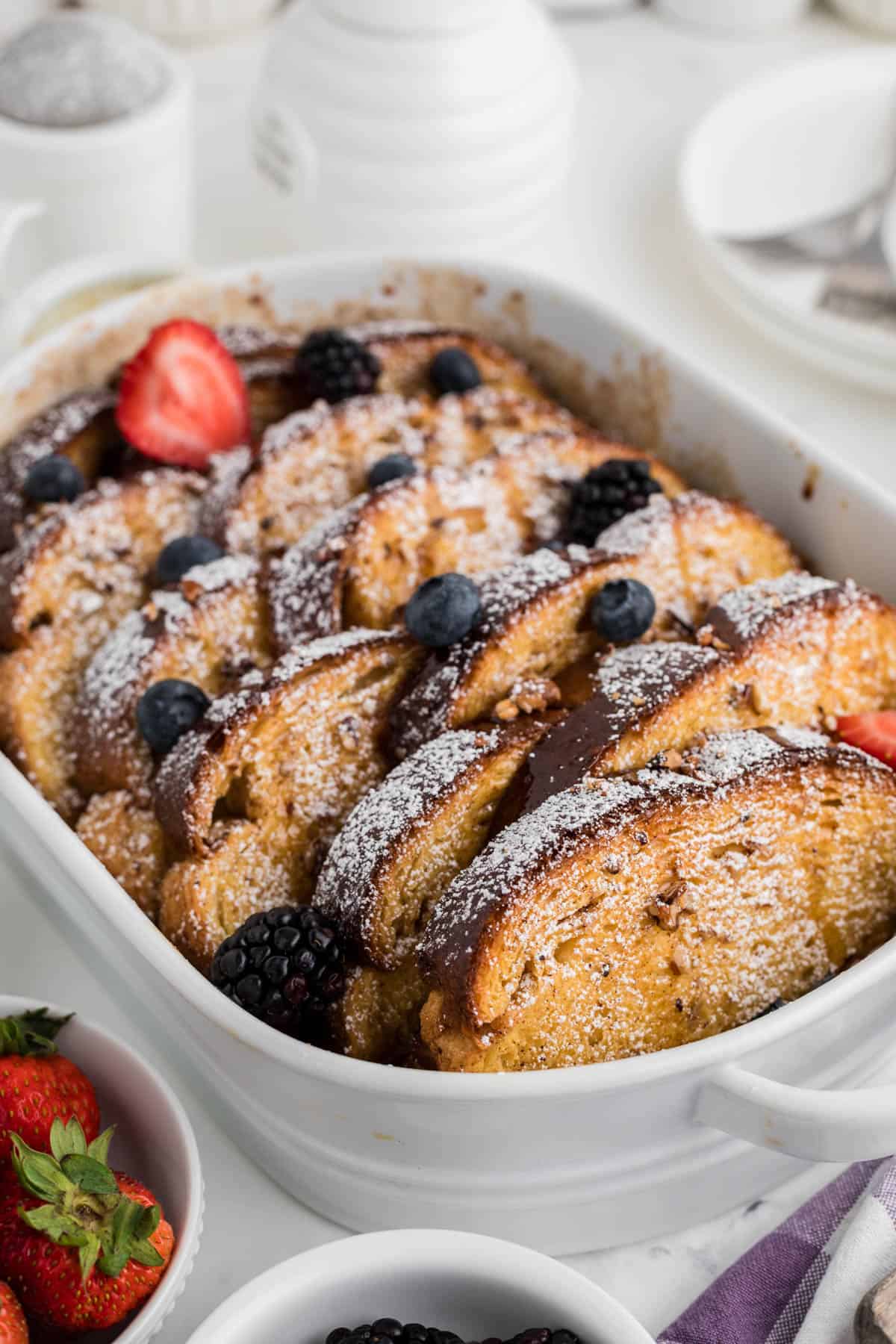 An image of baked overnight french toast in a white baking dish.