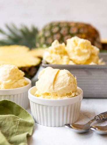 A scoop of pineapple ice cream in a white bowl.