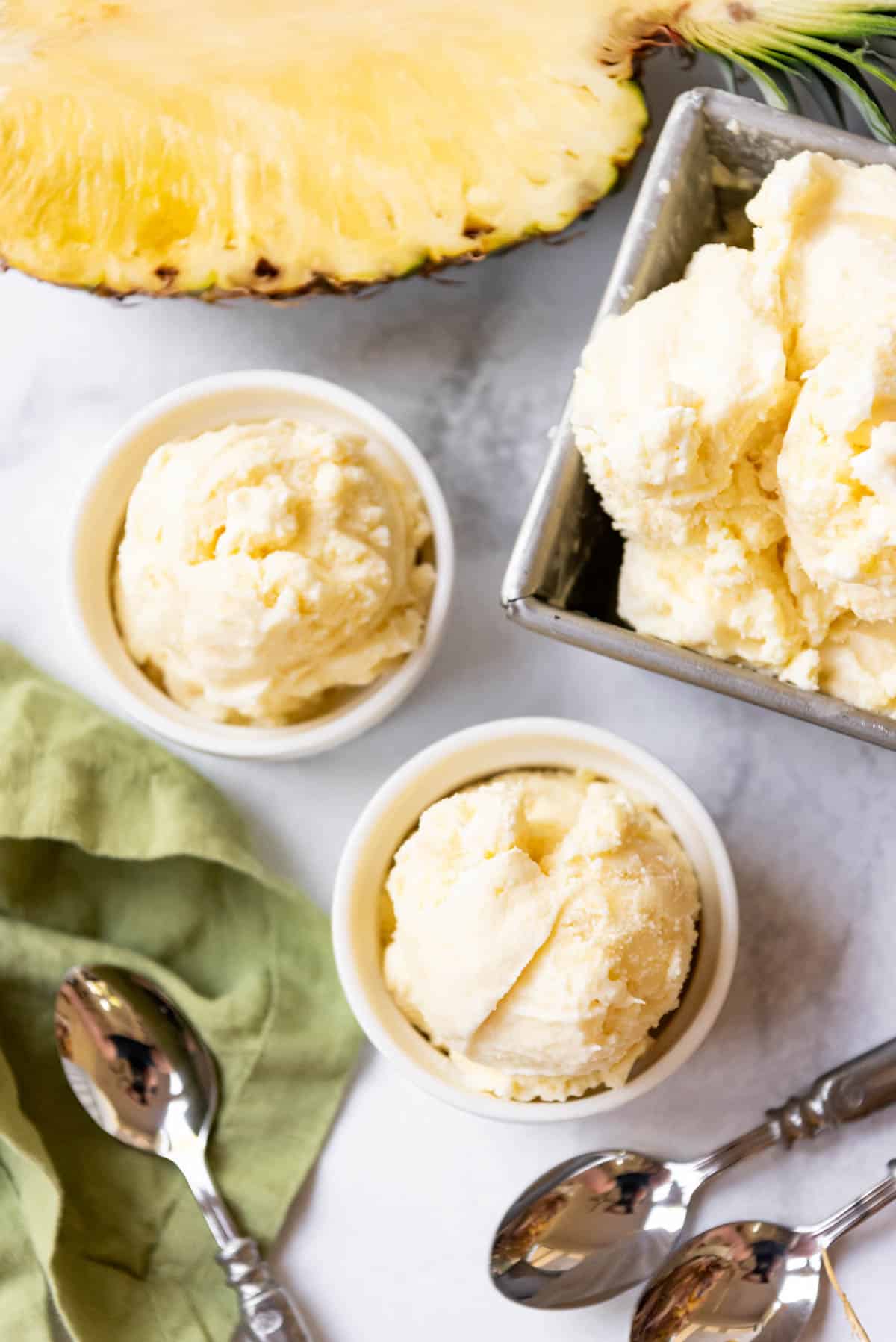 An overhead image of bowls of homemade pineapple ice cream.