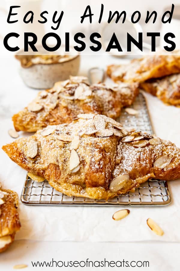 Almond croissants that have been dusted with powdered sugar and sprinkled with sliced almonds with text overlay.