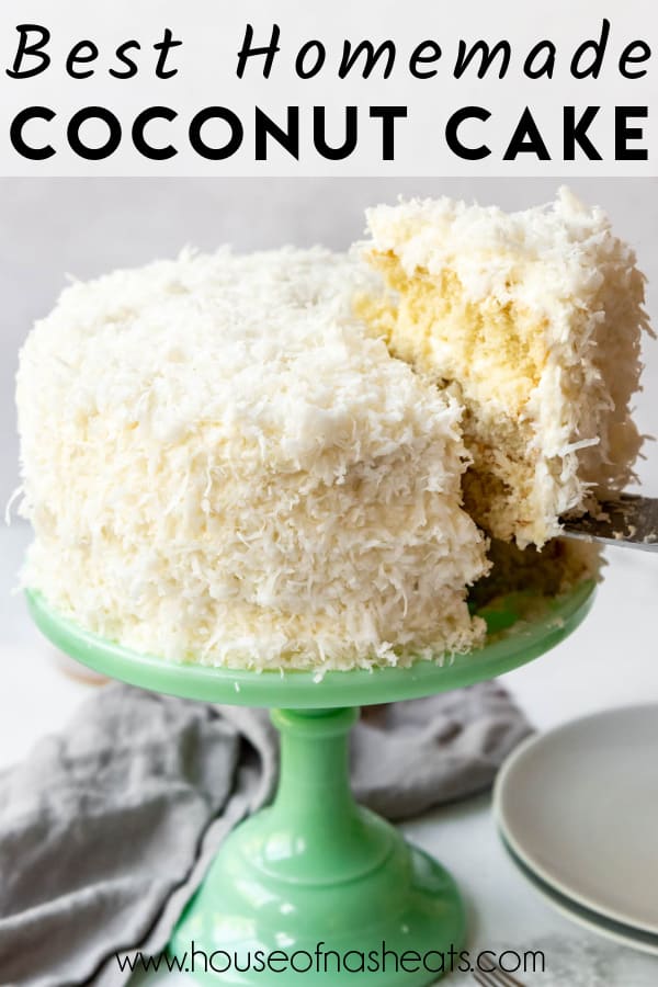 A homemade coconut cake with a slice being lifted from the cake stand with text overlay.