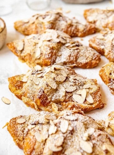 Fresh almond croissants dusted with powdered sugar.