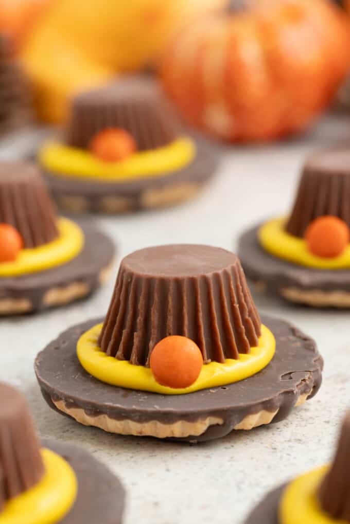 Fun pilgrim hat cookies made with Keebler fudge stripe shortbread cookies, frosting, mini M&M's, and Reese's miniature peanut butter cups.