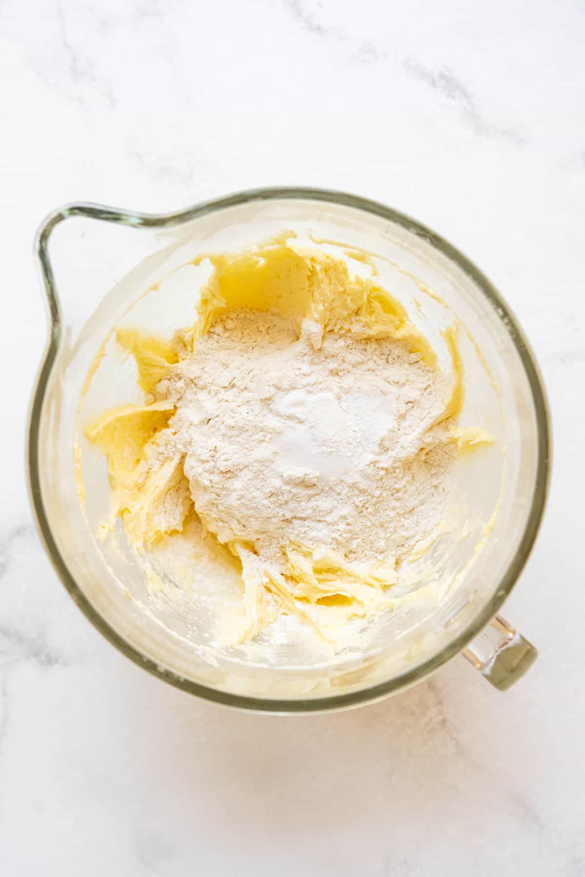 Adding flour to pastry dough for Gateau Basque.