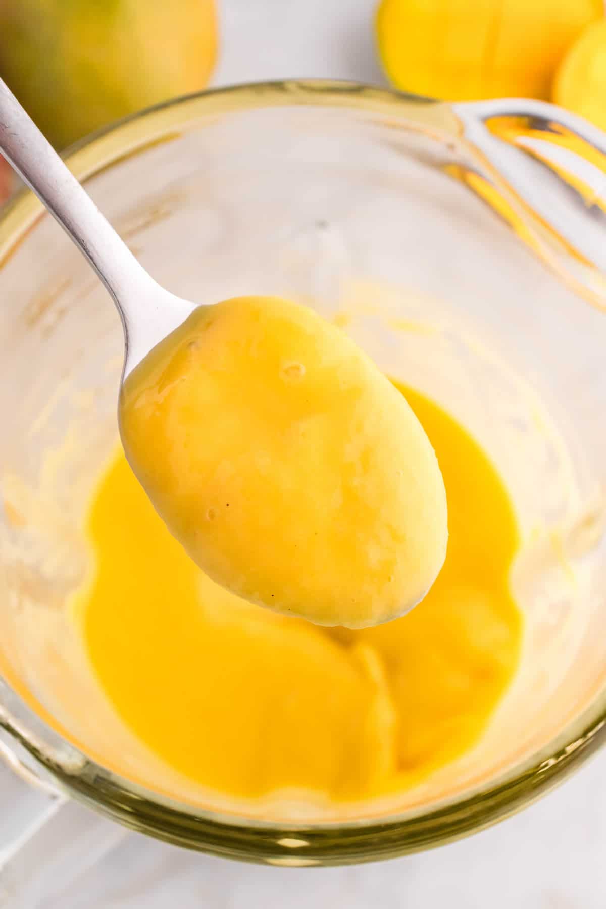 A spoonful of blended mango lassi.