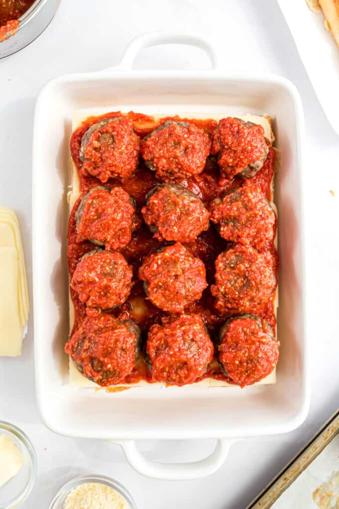 Topping meatballs with more sauce.