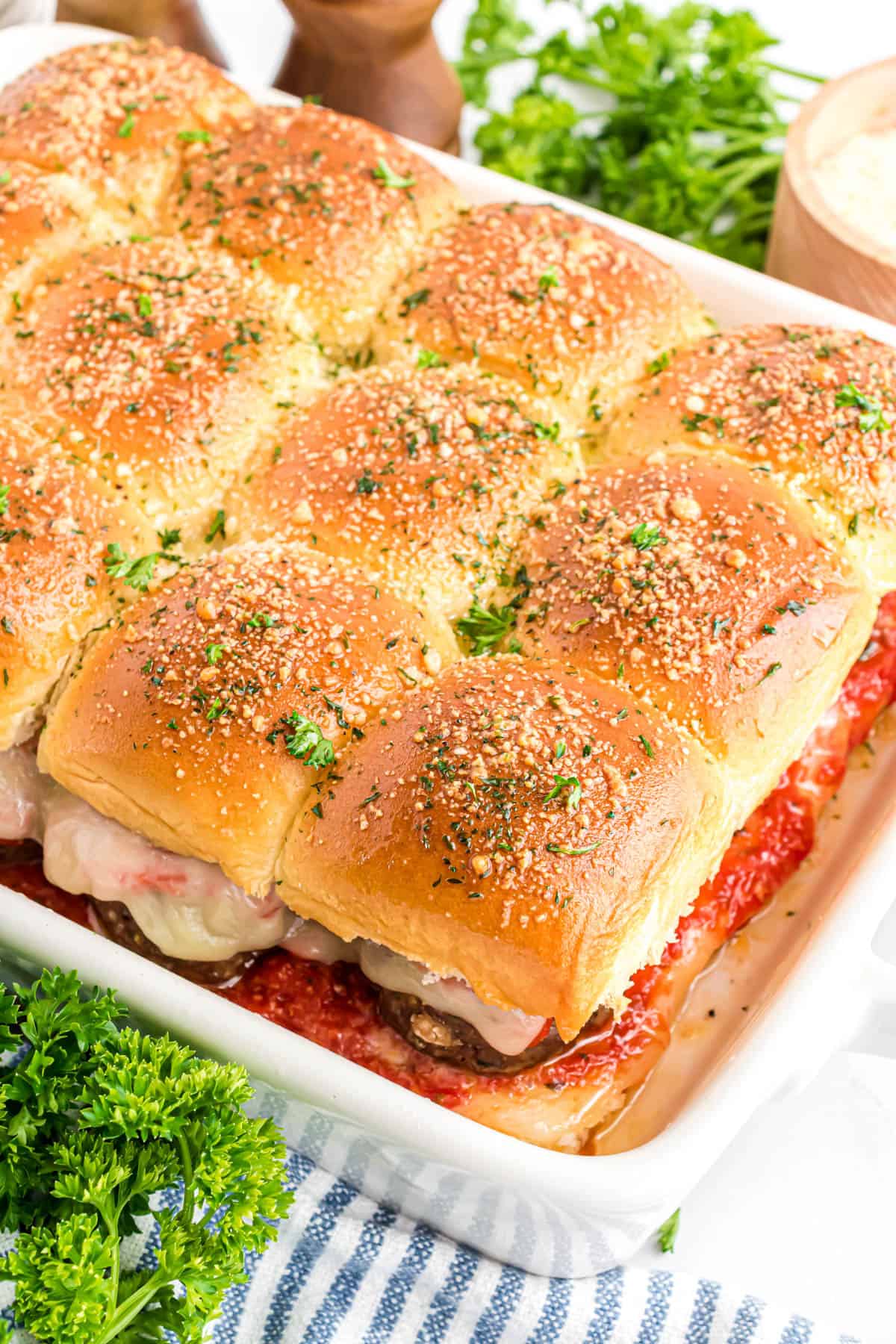 Meatball sliders in a white baking dish.