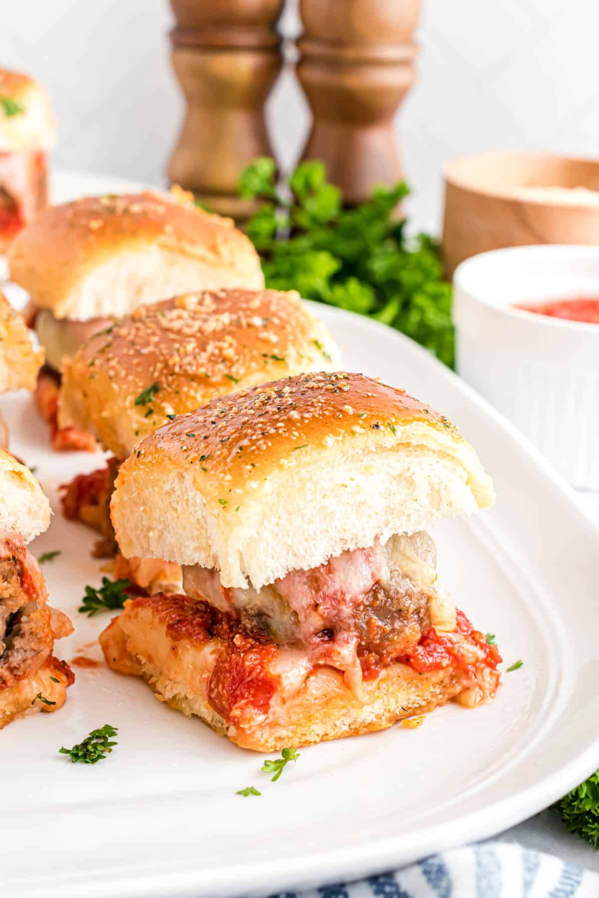 Meatball sliders on a white plate.