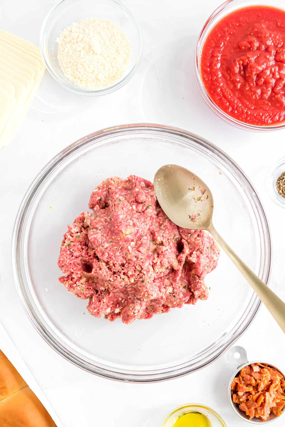 Meatball mixture in a glass bowl.