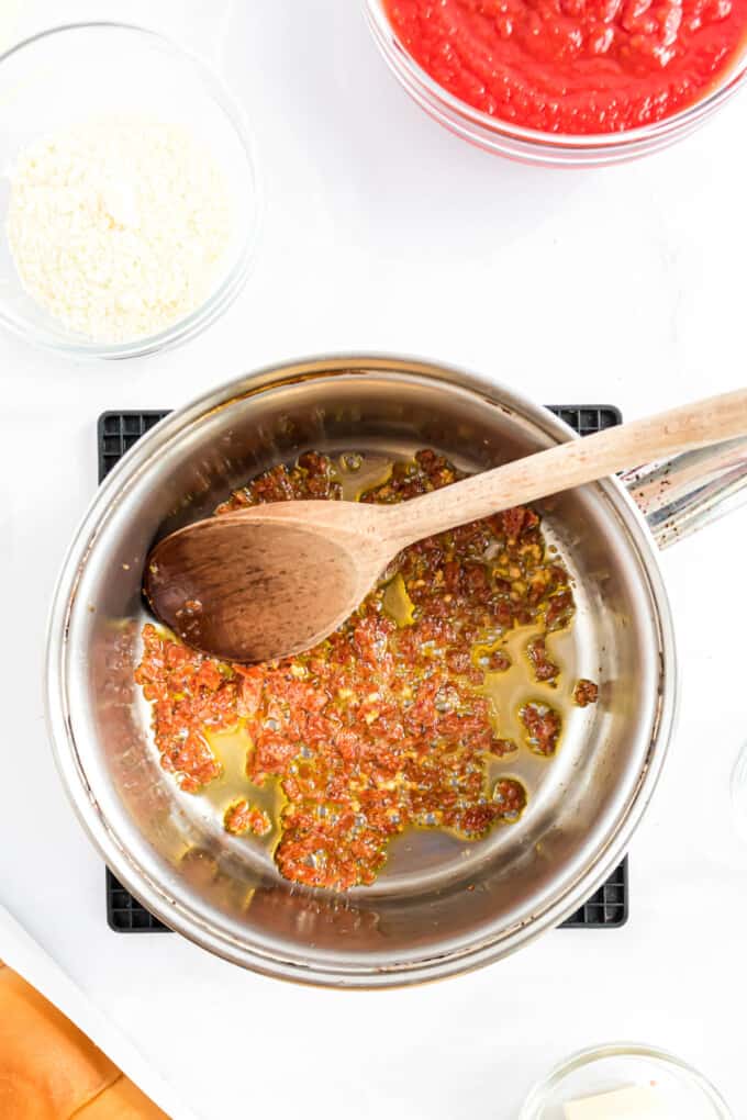 Sauteing garlic in oil in a saucepan.