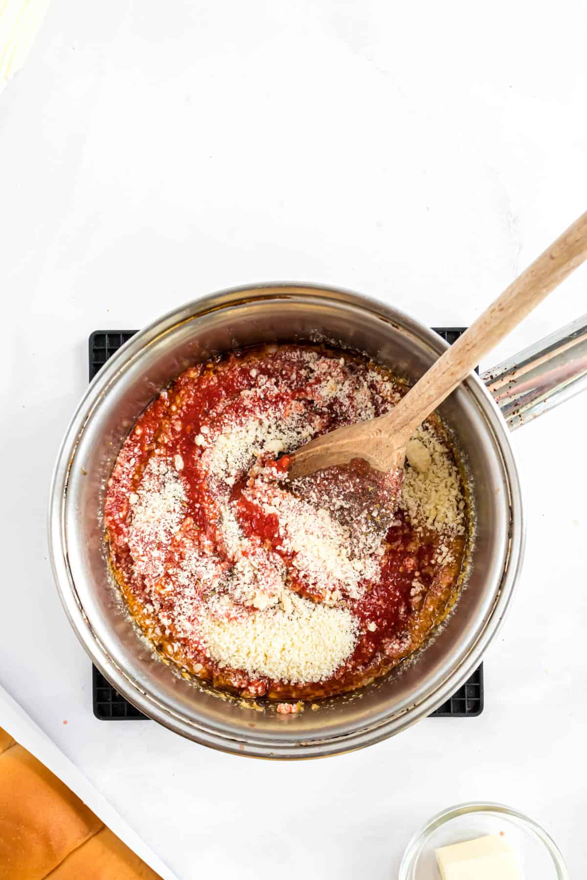 Stirring sauce ingredients for meatball sliders.