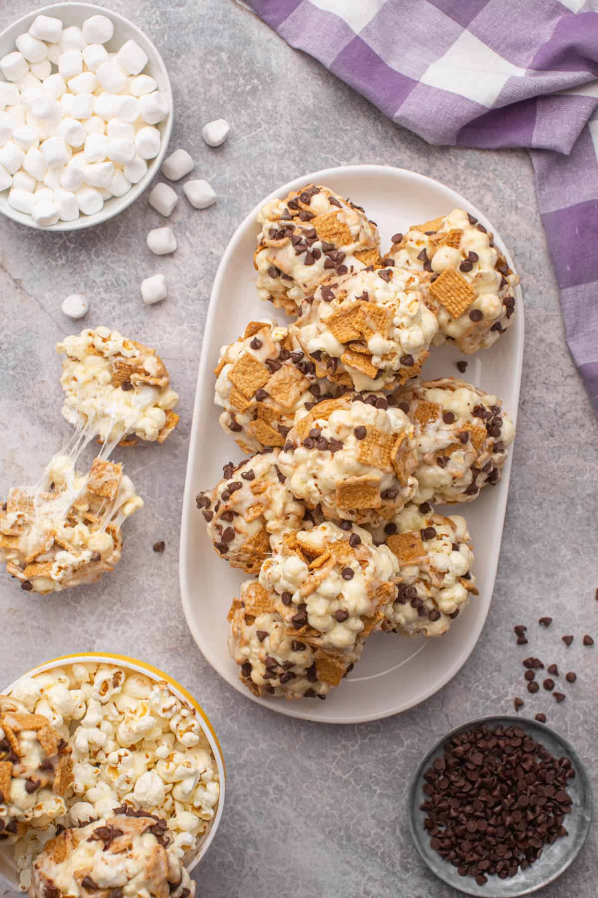 An overhead image of popcorn balls with chocolate chips and Golden Grahams cereal on a serving platter.