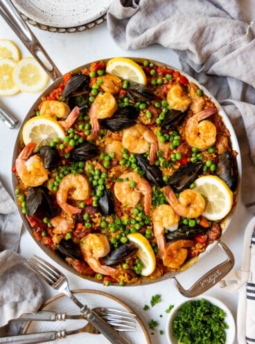 An overhead image of a large skillet of mixed Spanish seafood paella.