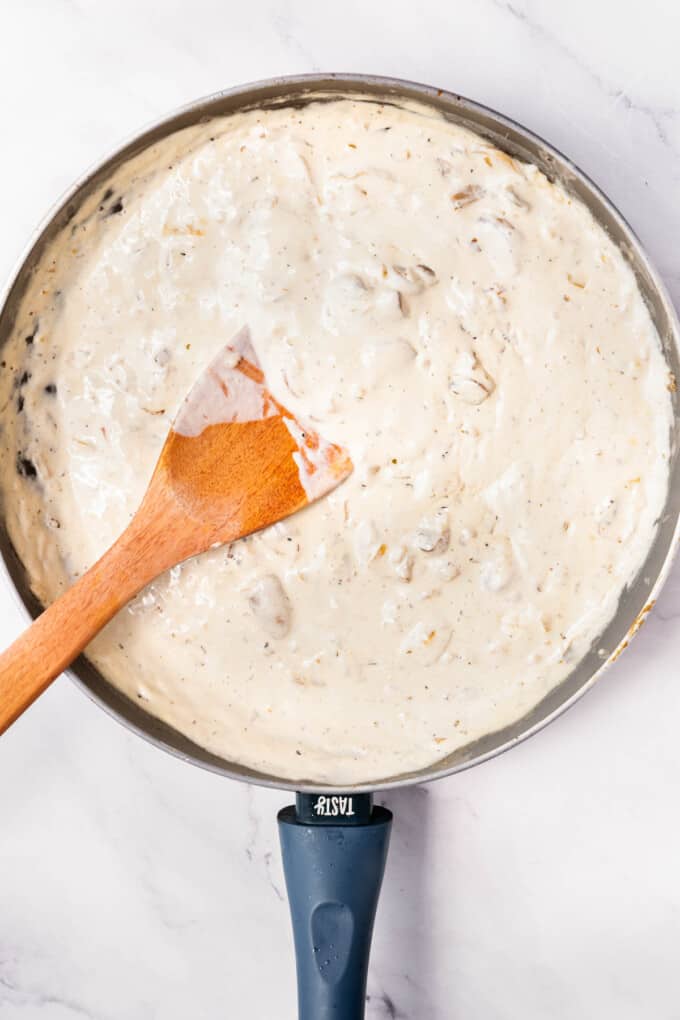 Creamy mushroom sauce in a large pan.