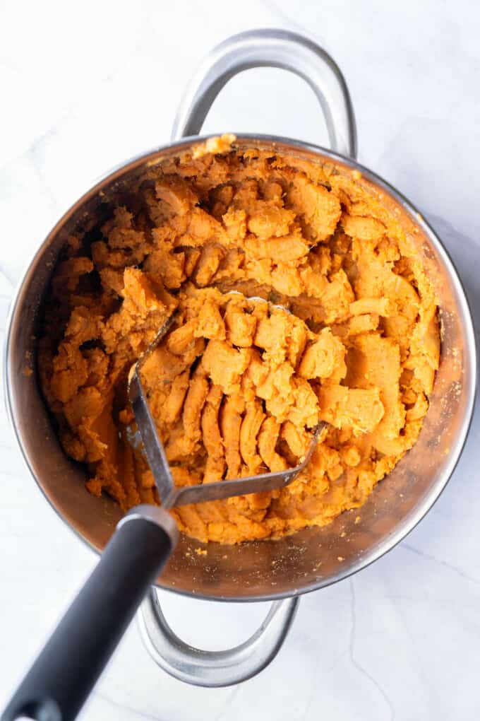 Mashed sweet potatoes in a large pot.