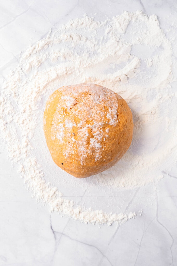 Sweet potato gnocchi dough on a floured surface.