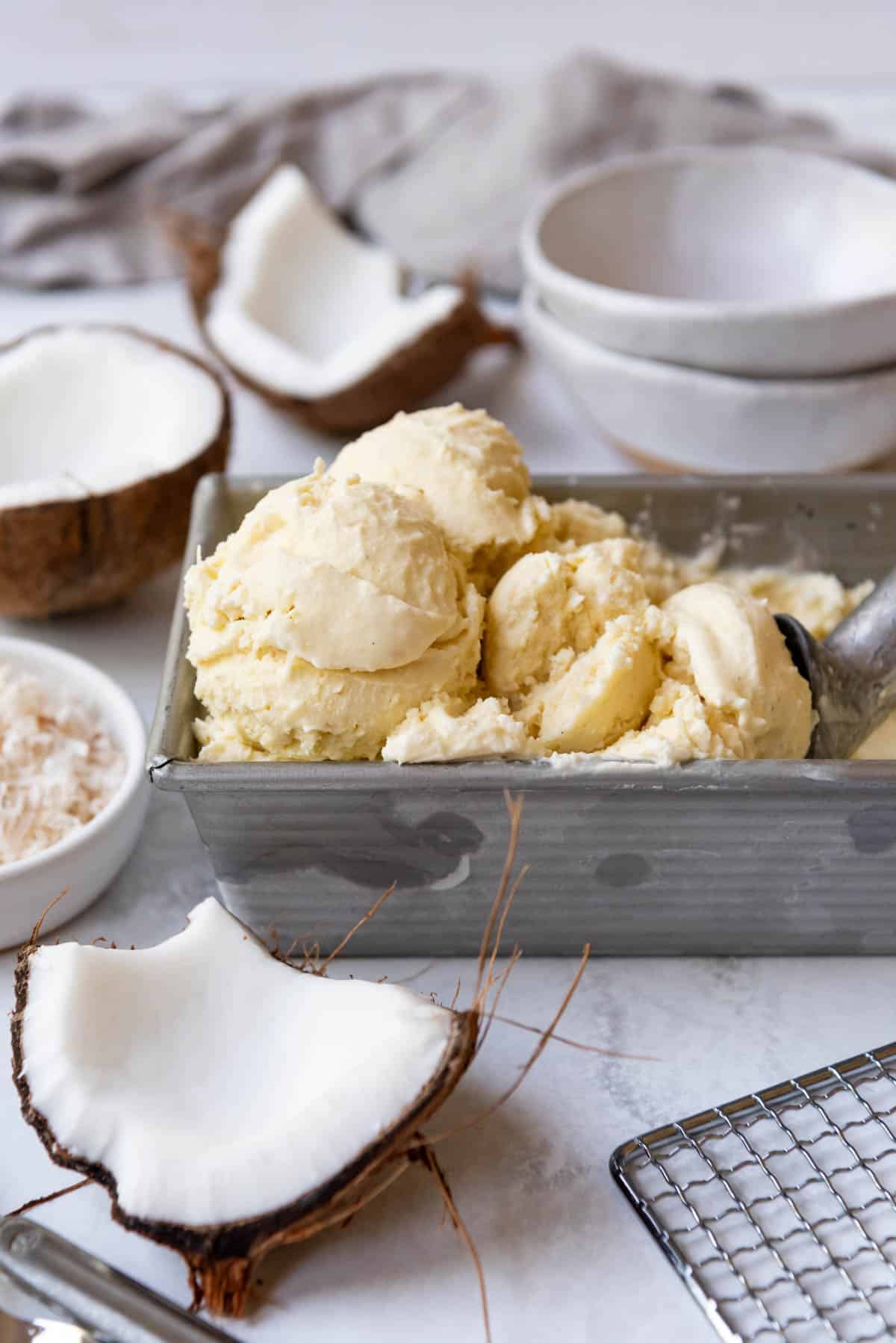 Coconut ice cream in a metal bread pan.