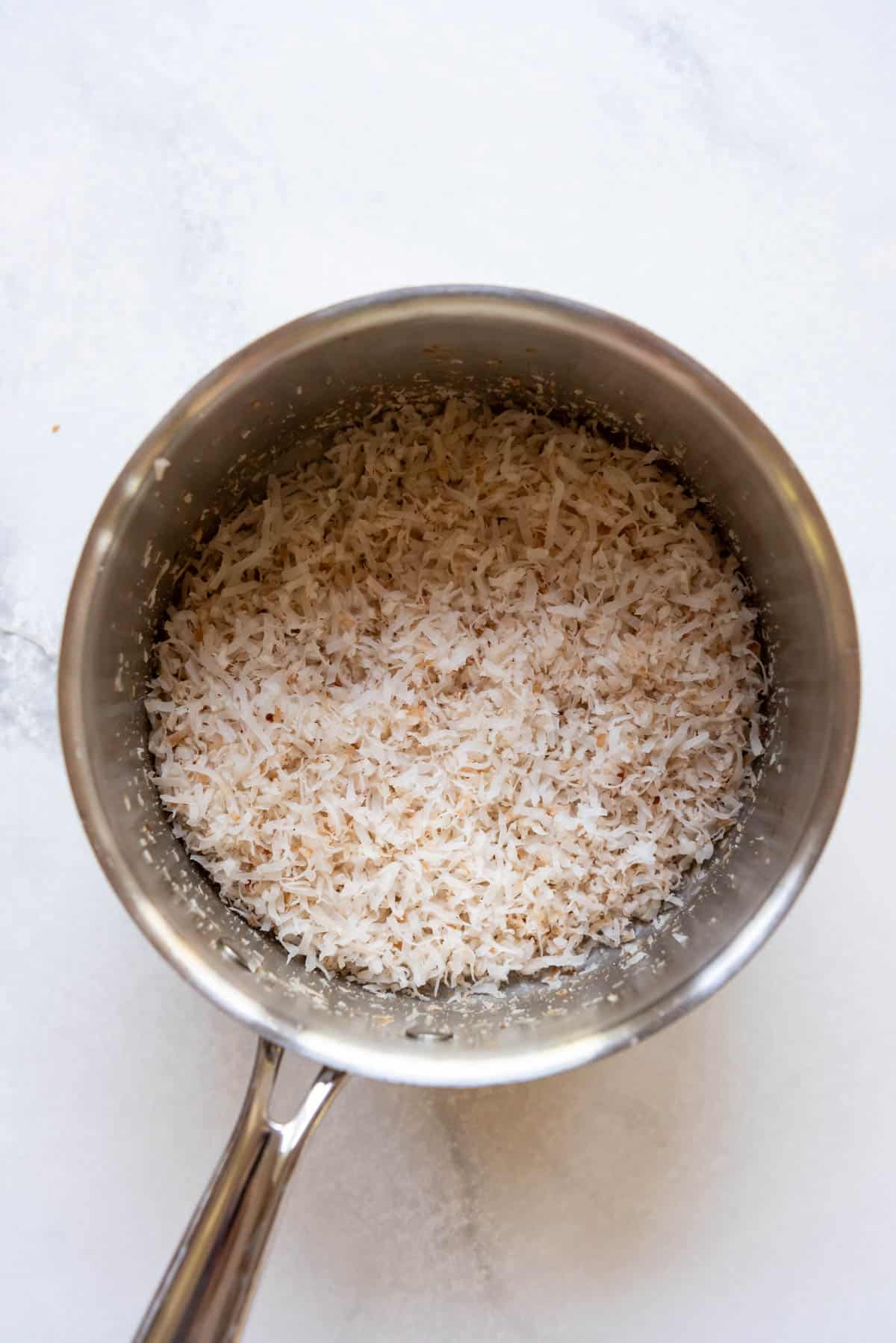 Toasted coconut in a saucepan.