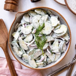 An overhead image of a bowl of creamy German cucumber salad.