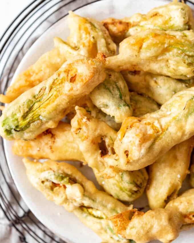 An overhead image of fried squash blossoms on a plate.