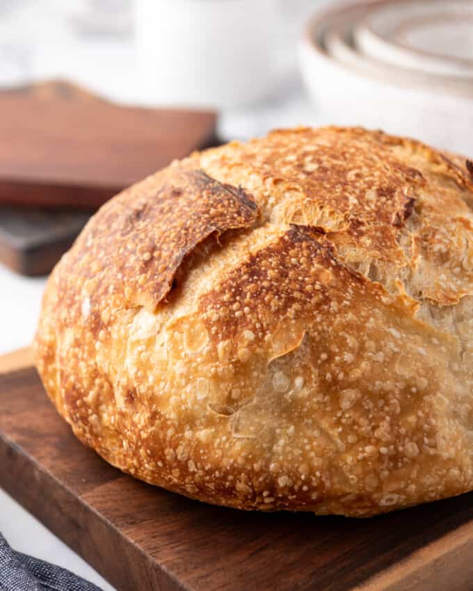 A close image of homemade sourdough bread with a golden brown crust.