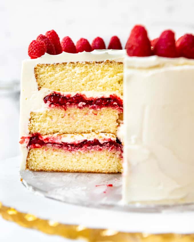 A close image of a cross section of a white chocolate raspberry cake.