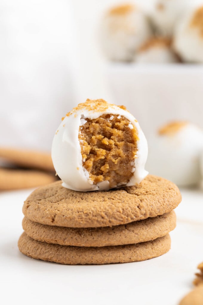 A gingerbread truffle on a stack of three gingersnaps.