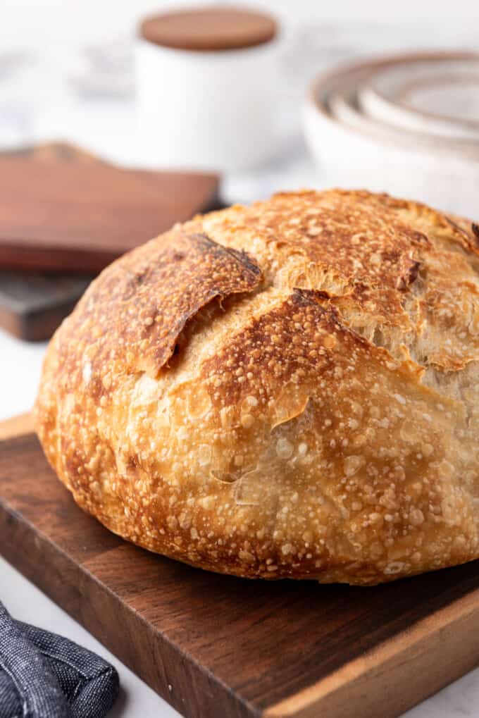 A close image of homemade sourdough bread with a golden brown crust.