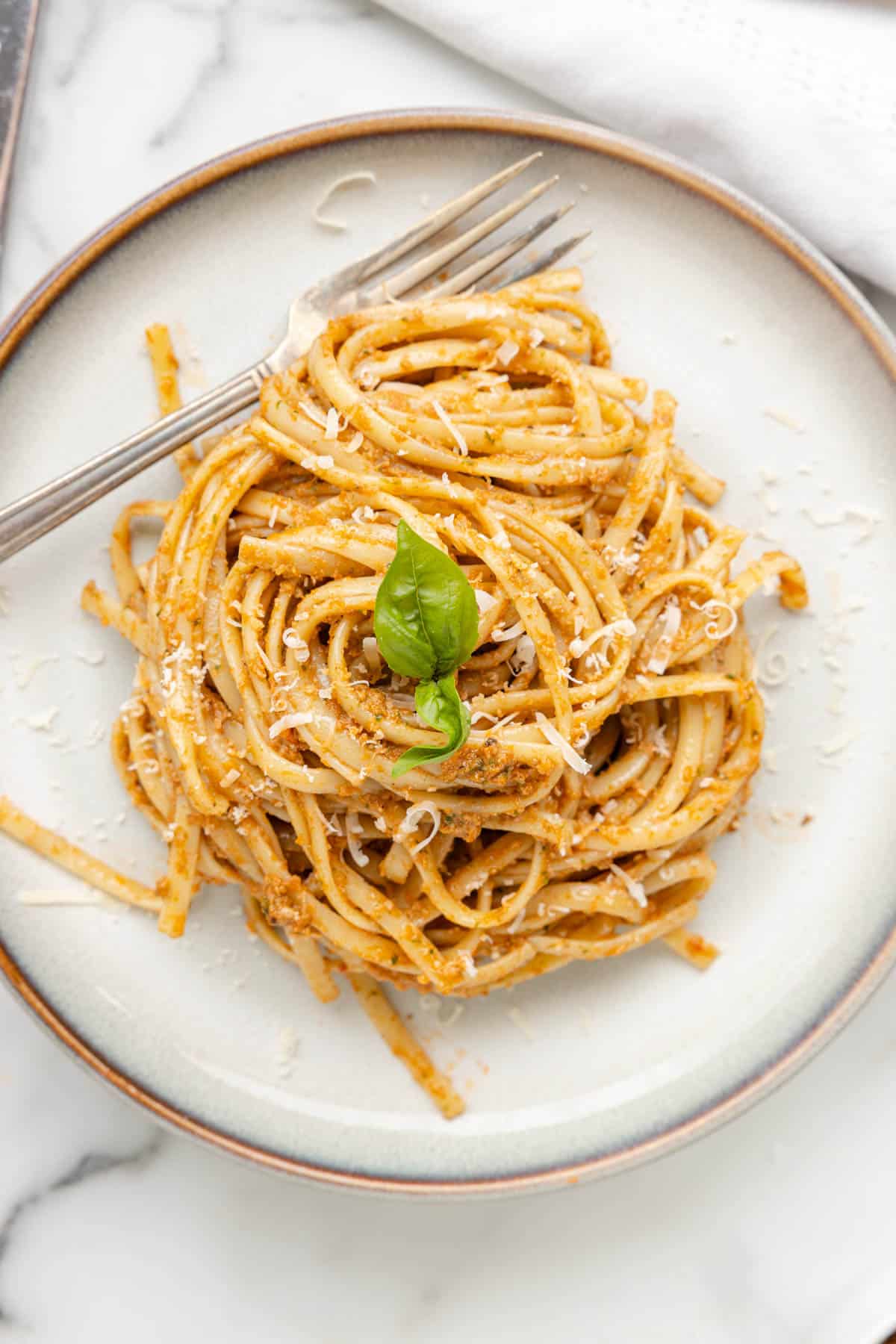 An overhead image of pasta made with sun-dried tomato pesto.