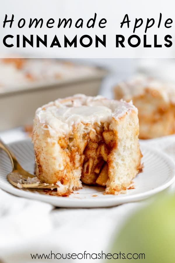 An apple cinnamon roll with a bite taken out of it on a plate with text overlay.