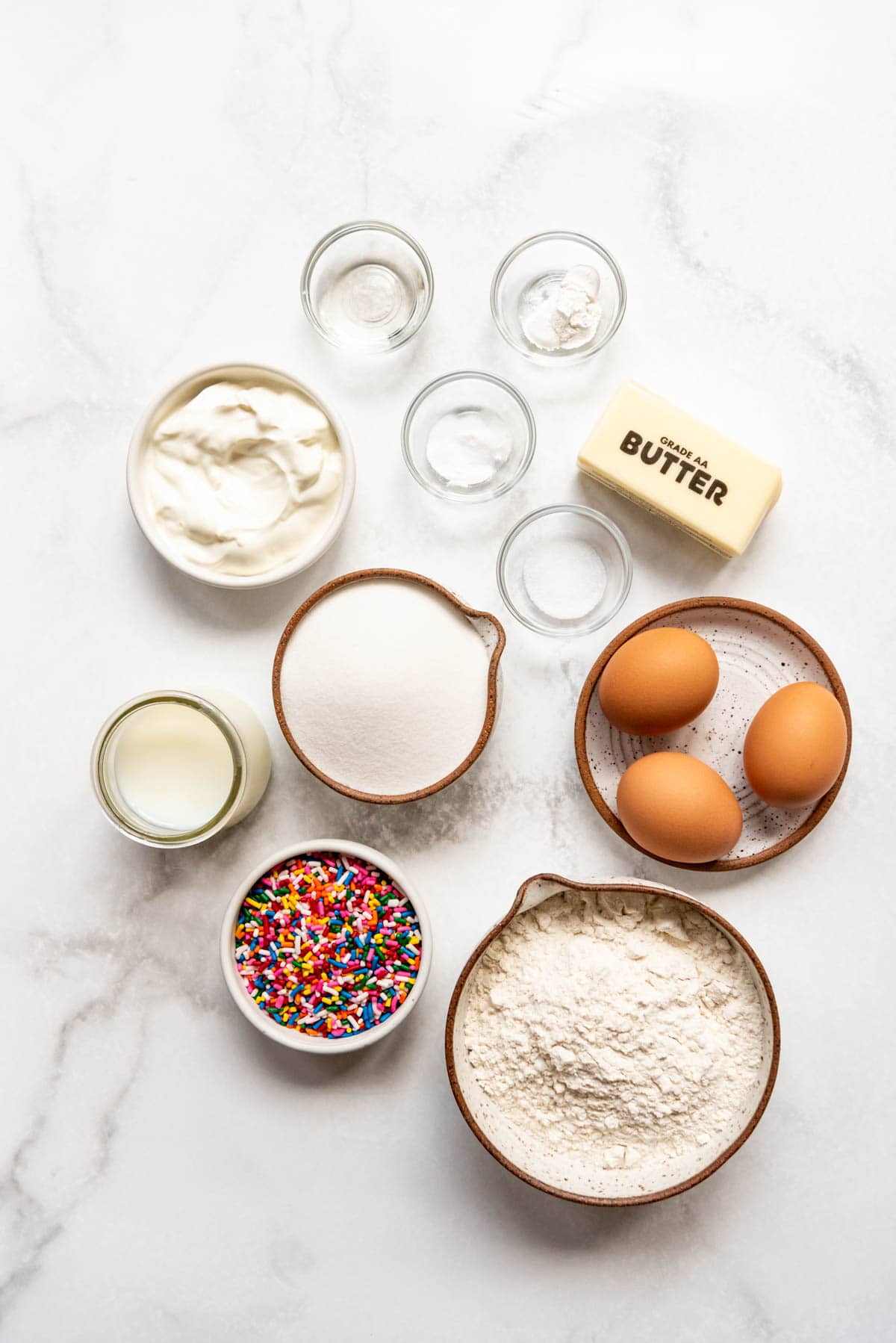 Ingredients for homemade funfetti cupcakes from scratch.