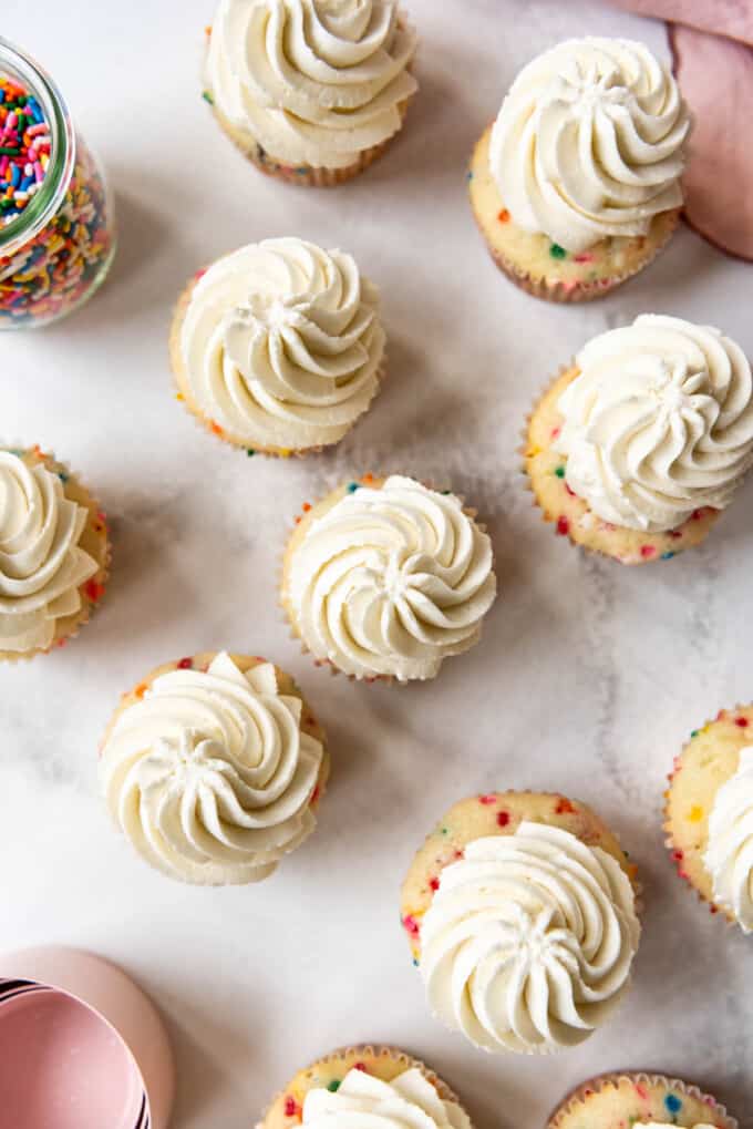 Cupcakes frosted with white buttercream frosting.