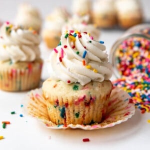 A homemade funfetti cupcake that has been unwrapped from its paper wrapper.