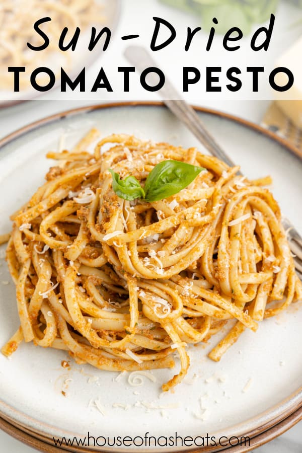 A plate of pasta tossed with sun-dried tomato pesto with text overlay.