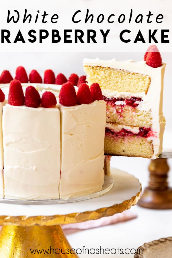 A slice of white chocolate raspberry cake being lifted from a cake stand with text overlay.