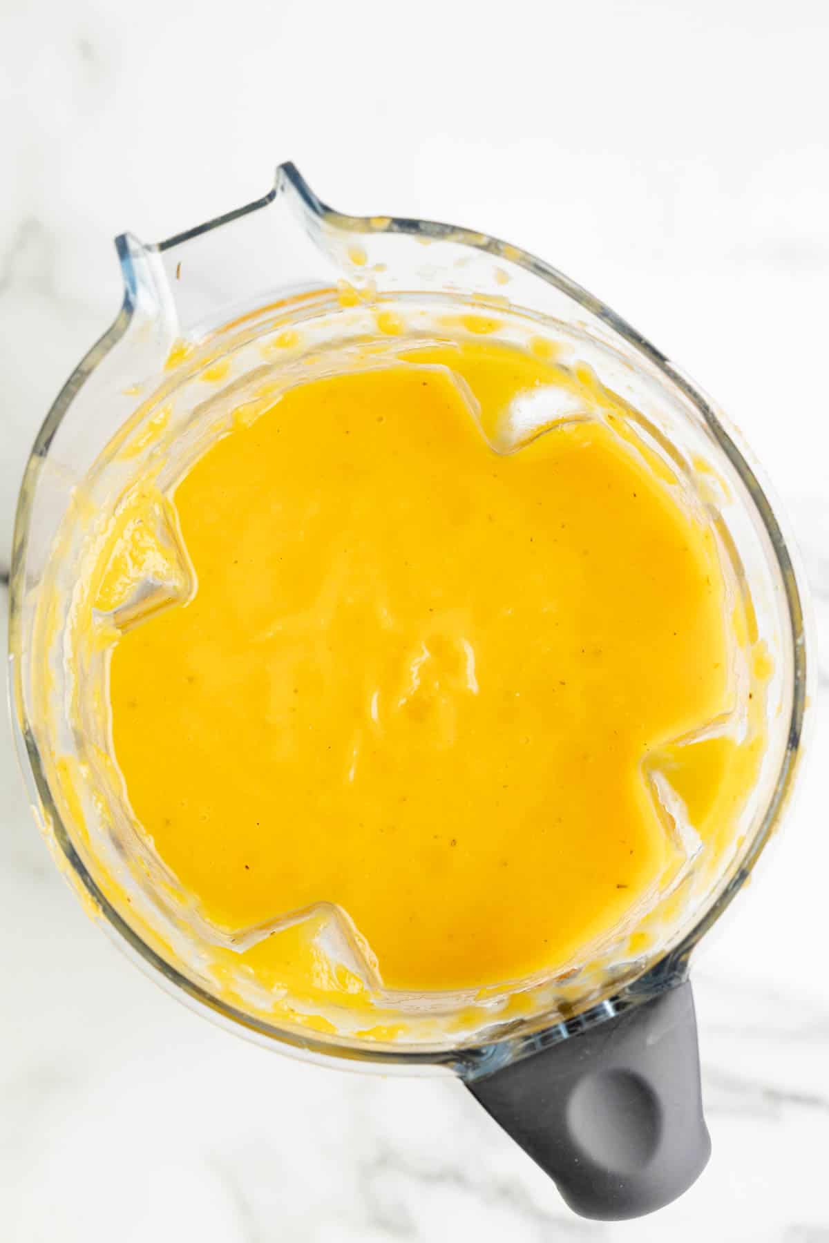 Blended butternut squash soup in a blender.