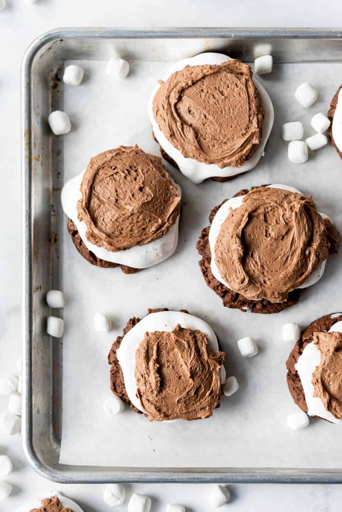 An overhead image of chocolate frosted chocolate marshmallow cookies.