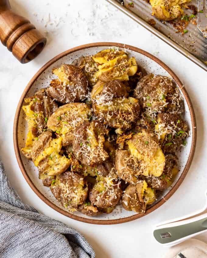 An overhead image of a plate of crispy smashed potatoes.