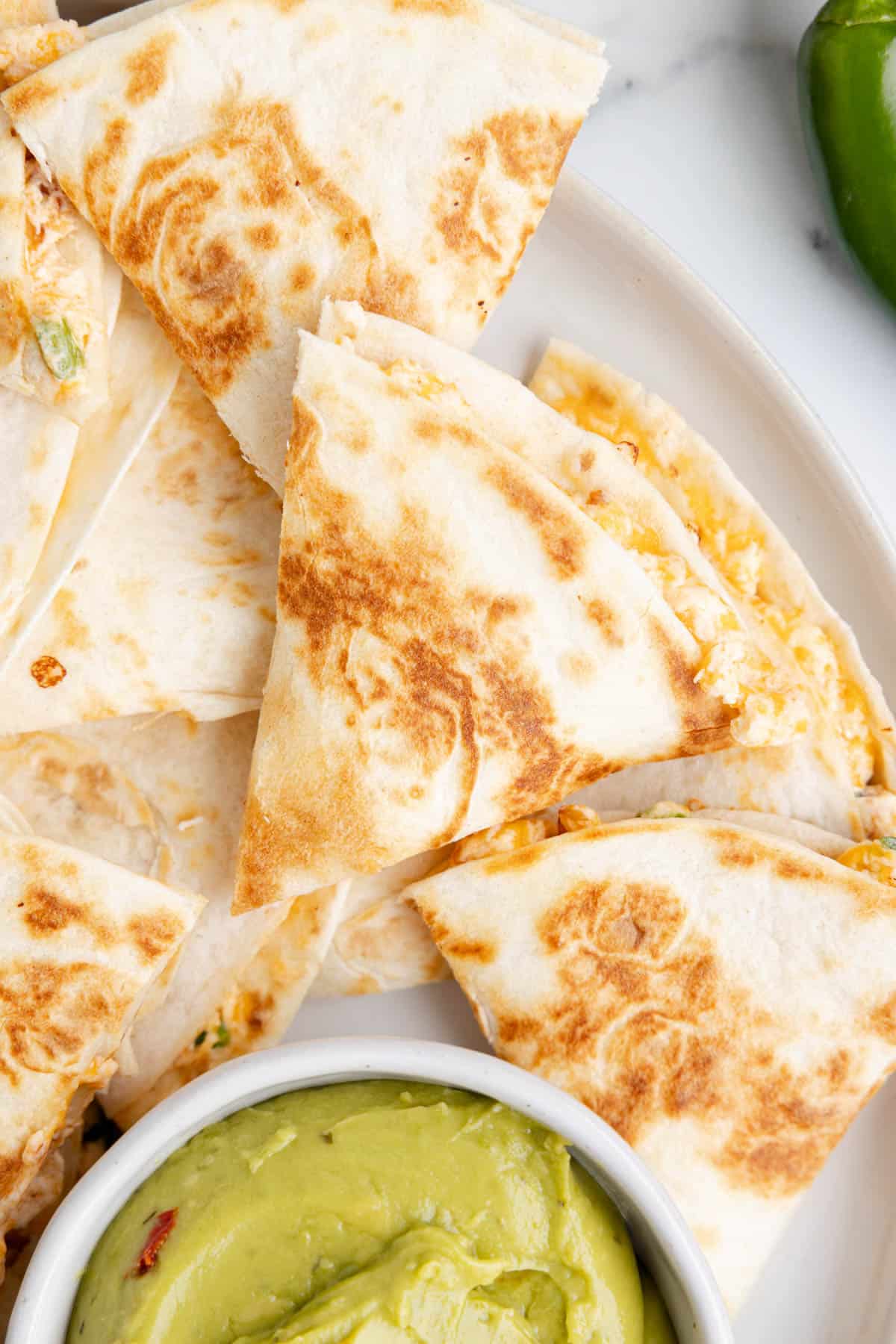Quesadillas that have been cut into triangles.