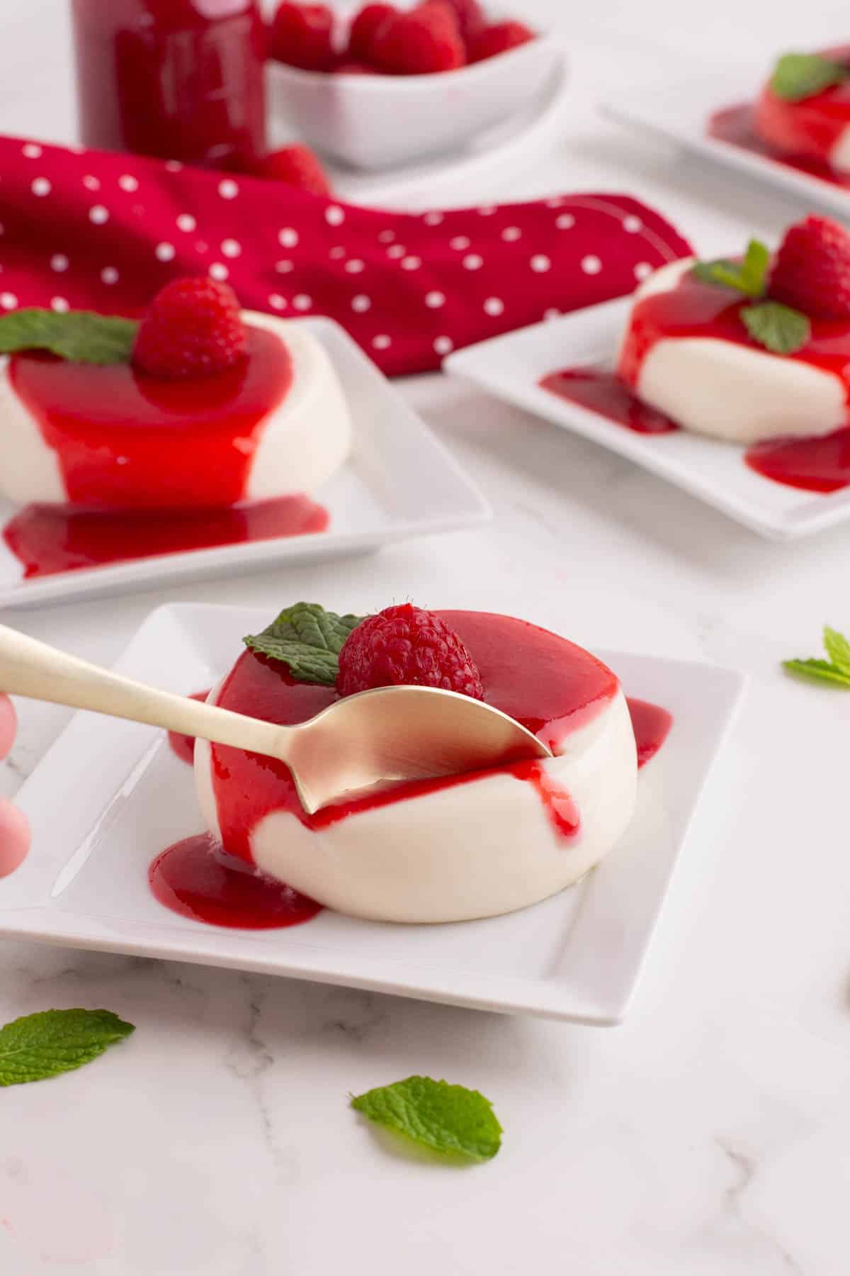 A spoon in a serving of panna cotta.