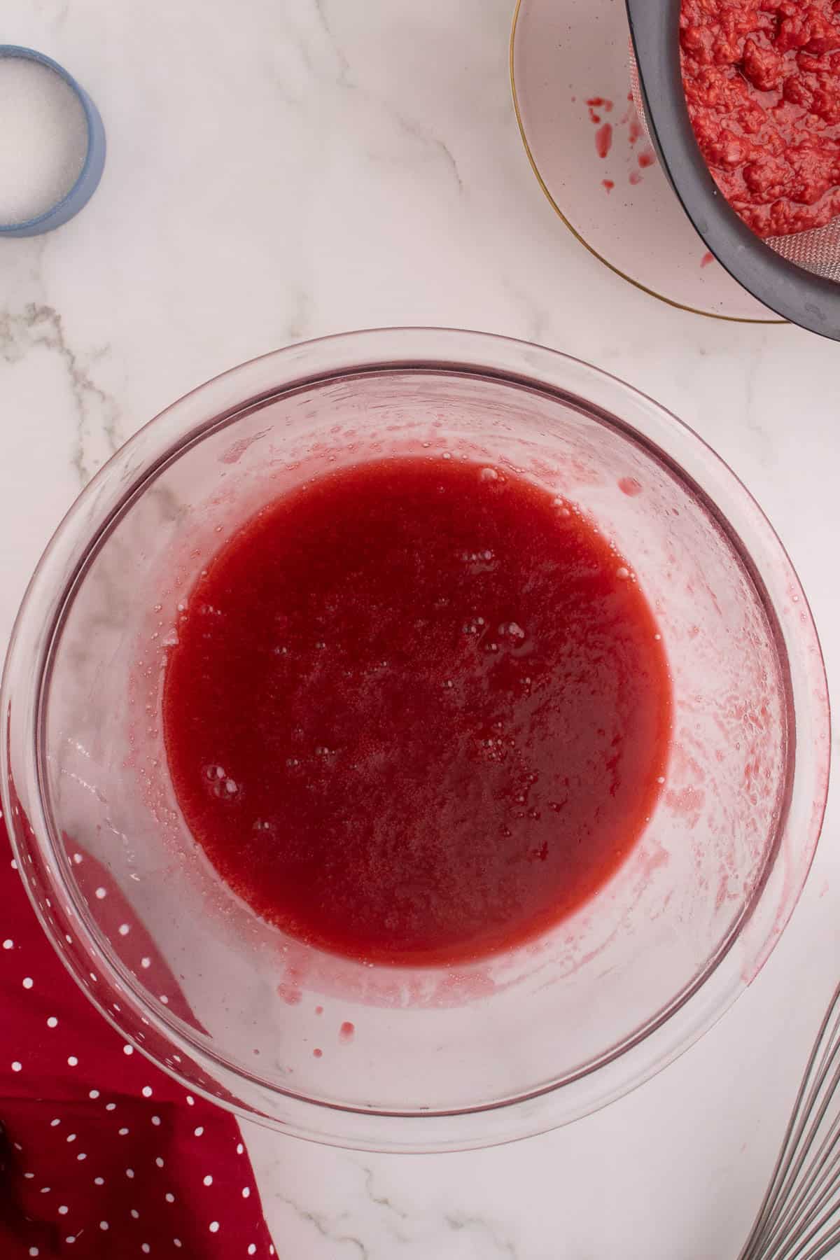 Strained raspberry sauce in a bowl.