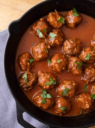 A close image of porcupine meatballs in rich tomato sauce.