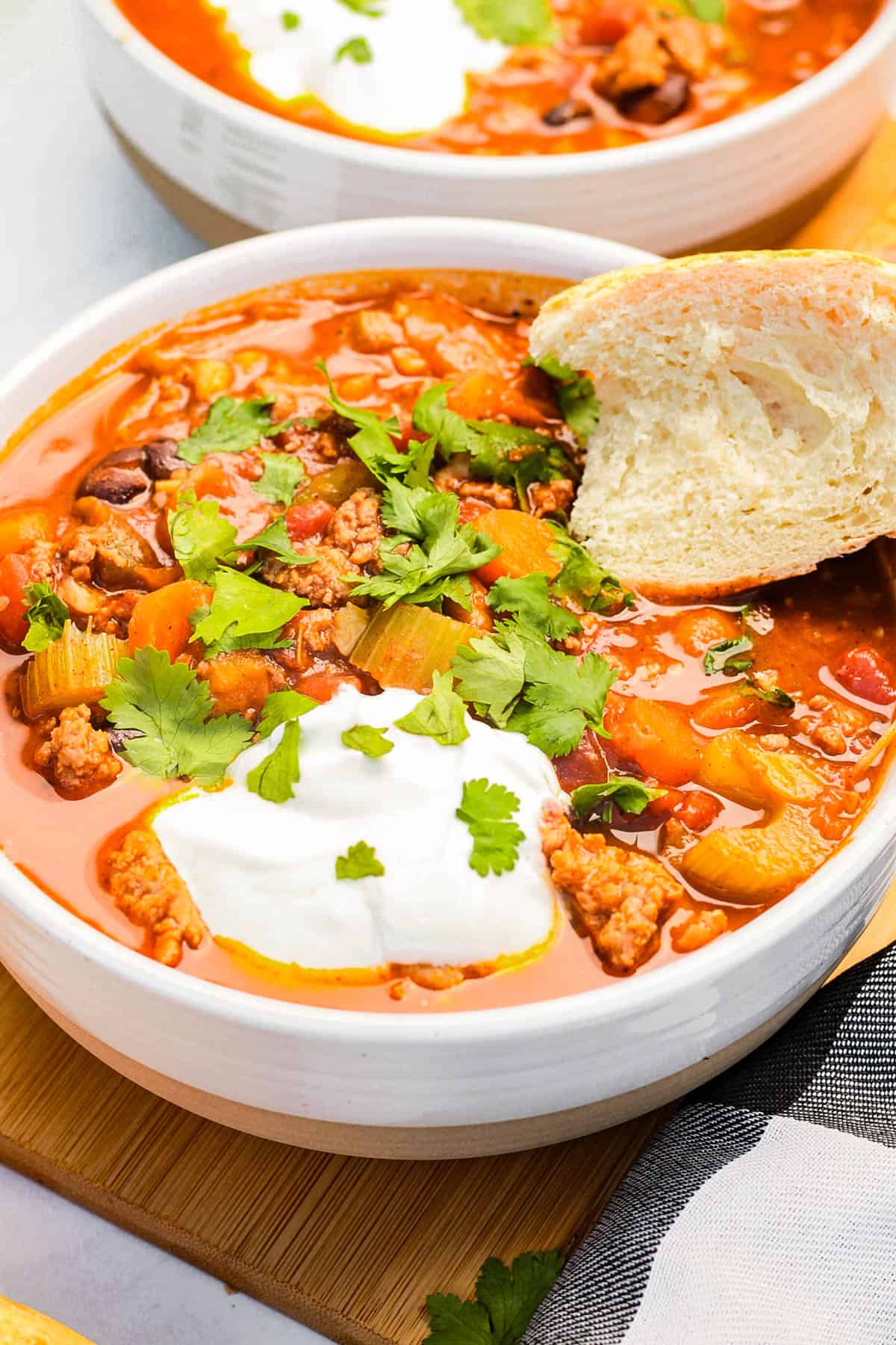 A bowl of pumpkin turkey chili with french bread.